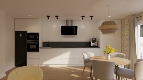 Cocina moderna con muebles blancos, electrodomésticos oscuros y mesa circular con sillas.